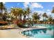 Relaxing pool area with palm trees and lounge chairs at 998 Nathan Ridge Rd, Clermont, FL 34715