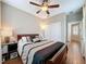 Well-lit bedroom with a ceiling fan and wood flooring at 111 Bayou Bend Rd, Groveland, FL 34736