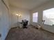 Bedroom featuring neutral carpet, two windows, and space for a desk, creating a versatile area at 12216 Wild Iris Way # 112, Orlando, FL 32837