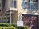 Building exterior featuring a brown garage door and second-floor balcony with metal railing at 12216 Wild Iris Way # 112, Orlando, FL 32837