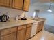 Kitchen boasts light wood cabinets, ample counter space, and a dishwasher at 12216 Wild Iris Way # 112, Orlando, FL 32837