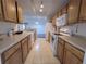 Open concept kitchen with light wood cabinets and modern appliances at 12216 Wild Iris Way # 112, Orlando, FL 32837