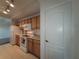 Well-equipped kitchen featuring light wood cabinets and modern appliances at 12216 Wild Iris Way # 112, Orlando, FL 32837