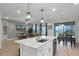 Open concept kitchen with island and adjacent dining area at 12545 Charmed Dr, Winter Garden, FL 34787