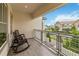 Relaxing balcony with gray wood-look floors and metal railing overlooking the neighborhood at 13444 Stoddart Ave, Orlando, FL 32827