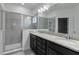 Double vanity bathroom with granite countertop and walk-in shower at 13444 Stoddart Ave, Orlando, FL 32827