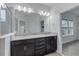 Double vanity bathroom with granite countertop and large mirror at 13444 Stoddart Ave, Orlando, FL 32827