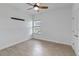 Bright bedroom with wood-look tile flooring and ceiling fan at 13444 Stoddart Ave, Orlando, FL 32827