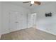 Spacious bedroom with double doors and wood-look tile floors at 13444 Stoddart Ave, Orlando, FL 32827