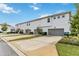 Rear view of townhouses with garages and landscaping at 13444 Stoddart Ave, Orlando, FL 32827