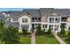 Two-story townhome with landscaping and brick walkway at 13444 Stoddart Ave, Orlando, FL 32827