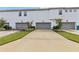 Three-car garage with driveway and landscaping at 13444 Stoddart Ave, Orlando, FL 32827
