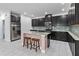 Modern kitchen with dark cabinets, granite counters, and island at 13444 Stoddart Ave, Orlando, FL 32827