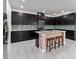 Modern kitchen with dark cabinets, granite counters, and island at 13444 Stoddart Ave, Orlando, FL 32827