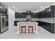 Modern kitchen with dark cabinets, granite counters, and island at 13444 Stoddart Ave, Orlando, FL 32827