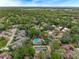 Aerial view of a community featuring mature trees, swimming pools, and tennis courts at 136 Woodmill Rd, Longwood, FL 32779