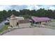 Aerial view of equestrian center featuring horse stables, riding arena, and paddocks at 136 Woodmill Rd, Longwood, FL 32779