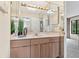 Mirrored bathroom with a skylight and a vanity with ample counter space at 136 Woodmill Rd, Longwood, FL 32779