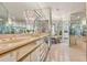 Elegant bathroom with a chandelier, tiled floor, marble countertops and mirrored walls at 136 Woodmill Rd, Longwood, FL 32779