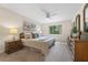Cozy bedroom featuring a ceiling fan, neutral tones, and an art piece above the bed at 136 Woodmill Rd, Longwood, FL 32779