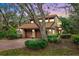 Beautiful two-story home featuring a red brick driveway and a two-car garage surrounded by mature landscaping at 136 Woodmill Rd, Longwood, FL 32779