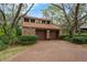 Two-story home featuring a two-car garage and a brick-paved driveway at 136 Woodmill Rd, Longwood, FL 32779
