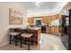 Charming eat-in kitchen featuring warm wood cabinetry, black appliances, and tile flooring at 136 Woodmill Rd, Longwood, FL 32779