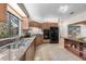 Spacious kitchen with wood cabinetry, modern appliances, granite countertops, and tile flooring at 136 Woodmill Rd, Longwood, FL 32779