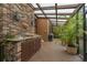 Outdoor lanai with a brick floor, bar, grill, and natural sunlight at 136 Woodmill Rd, Longwood, FL 32779