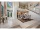 Open-concept living room featuring staircase, tiled floors, dining area and a large window at 136 Woodmill Rd, Longwood, FL 32779