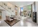 Bright, open-concept living room with a soaring ceiling, staircase, tile flooring, and large windows at 136 Woodmill Rd, Longwood, FL 32779