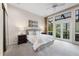 Comfortable main bedroom featuring a plush bed, generous natural light, and private outdoor access at 136 Woodmill Rd, Longwood, FL 32779