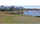 Putting green with lake and homes in background at 1400 Titian Ct, Reunion, FL 34747