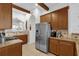 Kitchen with stainless steel appliances and wood cabinetry at 1400 Titian Ct, Reunion, FL 34747