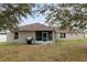 Spacious backyard with screened porch and grassy area at 149 Pine Rustle Ln, Auburndale, FL 33823