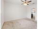 Bright bedroom with a ceiling fan and doorway leading to the en-suite bathroom at 1504 Finchburg St, Minneola, FL 34715