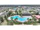 Aerial view showcases the neighborhood pool, clubhouse, and surrounding lush landscaping at 1504 Finchburg St, Minneola, FL 34715