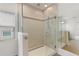 Modern shower with glass enclosure, tiled walls, and a rainfall shower head at 1504 Finchburg St, Minneola, FL 34715