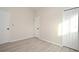 Simple bedroom with wood-look floors and neutral walls at 1904 Houndslake Dr, Winter Park, FL 32792