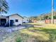 Large backyard with grassy area, shed, and wooden fence at 1968 Berkley Rd, Auburndale, FL 33823