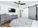 Bright bedroom with floral bedding, dresser, and barn door at 1968 Berkley Rd, Auburndale, FL 33823