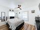 Bedroom with floral bedding, ceiling fan, and barn door at 1968 Berkley Rd, Auburndale, FL 33823