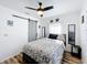 Bedroom with floral bedding, ceiling fan and barn door at 1968 Berkley Rd, Auburndale, FL 33823