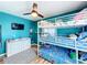 ' bedroom with a teal color, bunk beds, and ceiling fan at 1968 Berkley Rd, Auburndale, FL 33823