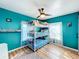 ' bedroom with a fun teal color, bunk beds, and a ceiling fan at 1968 Berkley Rd, Auburndale, FL 33823