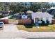 Front view of a charming house with a well-maintained lawn at 1968 Berkley Rd, Auburndale, FL 33823