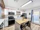 Modern kitchen with white shaker cabinets, quartz countertops, and island at 1968 Berkley Rd, Auburndale, FL 33823