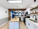 Bright kitchen with an island, white cabinets, and wood flooring at 1968 Berkley Rd, Auburndale, FL 33823