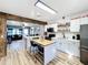 Open concept kitchen boasts an island and stainless steel appliances at 1968 Berkley Rd, Auburndale, FL 33823