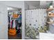 Clean bathroom with floral shower curtain and walk-in closet at 206 E South St # 6031, Orlando, FL 32801